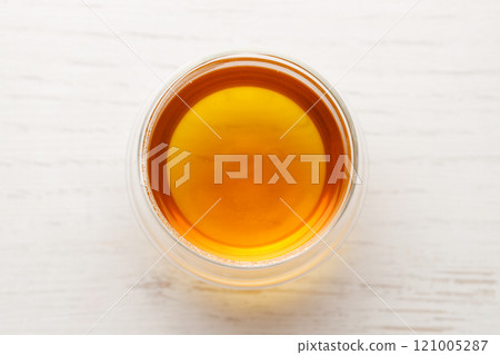 Cup of hot tea blended from rooibos, spearmint, apple, baobab on white wooden table. 121005287