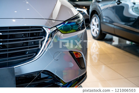 Car parked in luxury showroom. Car dealership office. Car showroom business. New car parked in modern showroom. Auto for sale and rent business. Automobile leasing and insurance. Electric automobile. 121006503