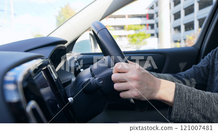 Car interior scene of a male driver driving a car 121007481
