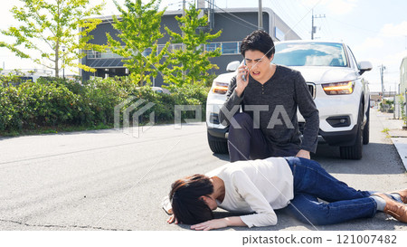 A driver who has caused a traffic accident and hastily reports it on his smartphone 121007482