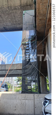ion stair behind net in highway contruction area in Thailand 121008357