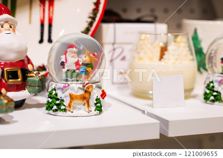 A beautifully crafted snow globe featuring Santa Claus and reindeer inside of it A beautifully crafted snow globe featuring Santa Claus and reindeer inside of it 121009655