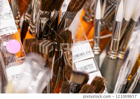 A collection of various makeup brushes neatly organized in a clear container A collection of various makeup brushes neatly organized in a clear container 121009657