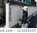 A male craftsman painting the wall of a Japanese-style house with a brush 121010125