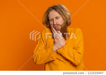 Caucasian man touching cheek closing eyes with expression of terrible suffer from painful toothache 121010447