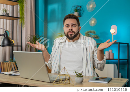 Confused man feeling embarrassed about ambiguous question having doubts no idea at home, lifestyle 121010516