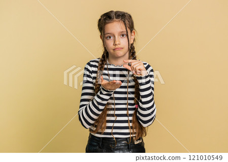 Child girl show a little bit gesture begging help need some more please give me measuring small size 121010549