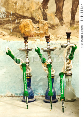 Hookah standing on the ground, on the street, outdoors. Concept of bad habits, unhealthy lifestyle. 121011187