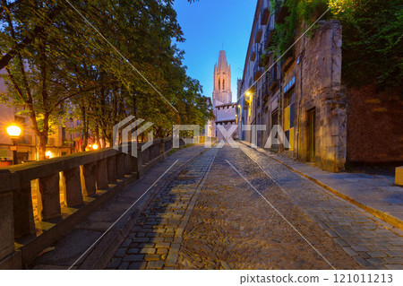 Old historic street illuminated at night in Girona, Spain 121011213