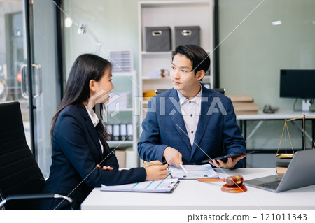business people and lawyers discussing contract papers sitting at the table. Concepts of law, advice, legal services. business people and lawyers discussing contract papers sitting at the table. Concepts of law, advice, legal services. 121011343