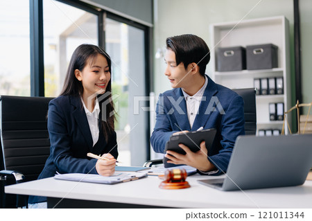 Asian business team and lawyers discussing contract papers sitting at the table. Concepts of law, advice, legal services. Asian business team and lawyers discussing contract papers sitting at the table. Concepts of law, advice, legal services. 121011344