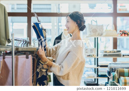A woman choosing a kimono A woman choosing a kimono 121011699