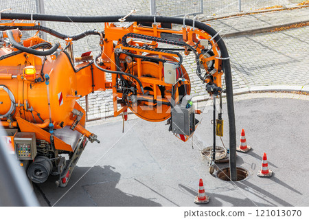 Pipe hose sewage truck car engine emptying city street sewerage manhole. Septic cleaning vacuum service maintenance technology equipment industry. Suction vehicle cleaner machine pumping drainage 121013070