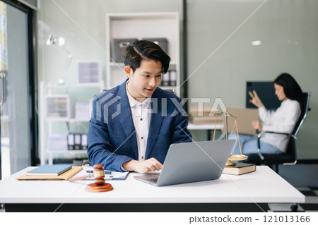 Asian man lawyer working and gavel, tablet, laptop in front, Advice justice and law concept. Asian man lawyer working and gavel, tablet, laptop in front, Advice justice and law concept. 121013166