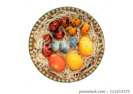 Easter eggs in ceramic plate. Isolate on a white background. Easter traditions. Variety of homemade painted eggs. Rustic style. 121014375