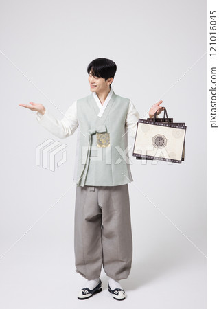 Portrait of a young man wearing hanbok and holding shopping bags Portrait of a young man wearing hanbok and holding shopping bags 121016045