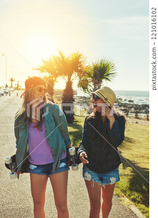 Summer is about skateboarding. Shot of two friends hanging out on the boardwalk with a skateboard. 121016102