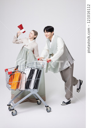 A Korean man wearing a hanbok and shopping with a shopping cart and a foreign woman holding a loudspeaker A Korean man wearing a hanbok and shopping with a shopping cart and a foreign woman holding a loudspeaker 121016112