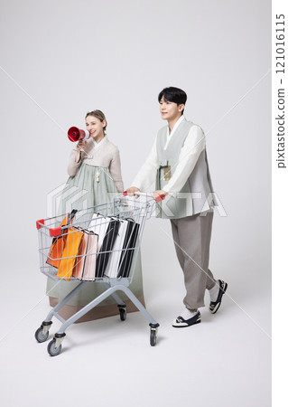 A Korean man wearing a hanbok and shopping with a shopping cart and a foreign woman holding a loudspeaker A Korean man wearing a hanbok and shopping with a shopping cart and a foreign woman holding a loudspeaker 121016115