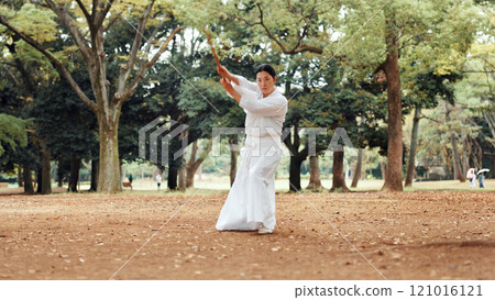 Woman, fitness or sword in nature for martial arts, demonstration or training tradition in Kyoto. Japanese samurai, weapon or indigenous culture in park for kendo, practice or self defense technique 121016121