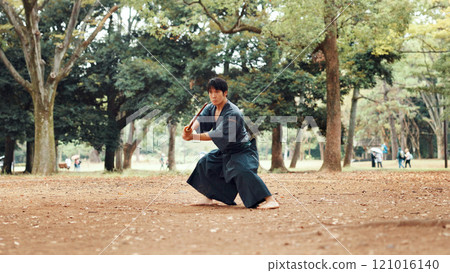 Man, fitness and sword in nature for martial arts, demonstration and training tradition in Kyoto. Japanese samurai, weapon and indigenous culture in park for kendo, practice or self defense technique 121016140