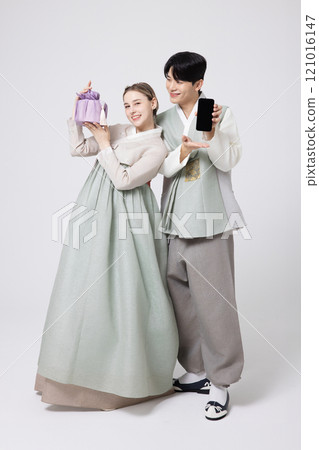 A foreign woman and a Korean man wearing hanbok and holding carefully prepared gifts A foreign woman and a Korean man wearing hanbok and holding carefully prepared gifts 121016147