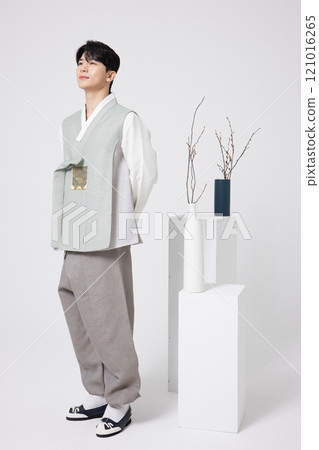A young man standing wearing a hanbok A young man standing wearing a hanbok 121016265