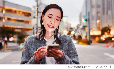Smile, woman and typing in city with phone, connection and online chat for morning commute. Smartphone, search and Japanese person on street with app for social media, communication and urban travel 121016301