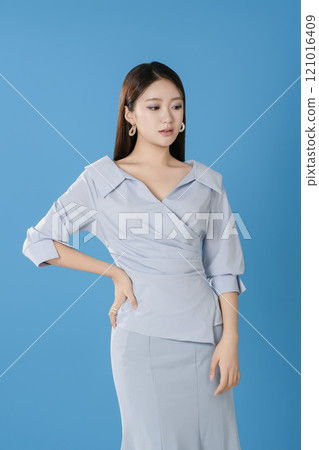 A woman posing in a light blue dress 121016409