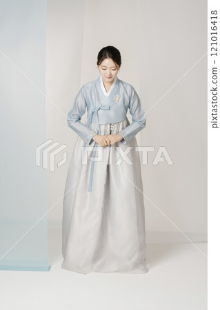 A beautiful woman greeting you wearing an elegant Hanbok. A beautiful woman greeting you wearing an elegant Hanbok. 121016418