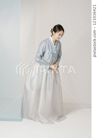 A beautiful woman greeting you wearing an elegant Hanbok. A beautiful woman greeting you wearing an elegant Hanbok. 121016421