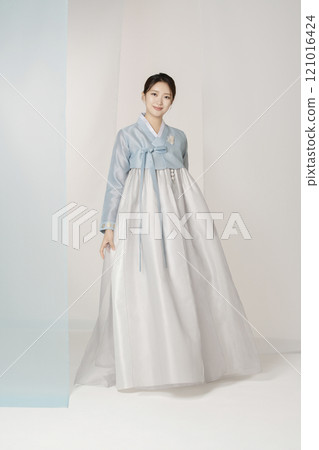 A beautiful woman standing wearing an elegant and elegant hanbok A beautiful woman standing wearing an elegant and elegant hanbok 121016424