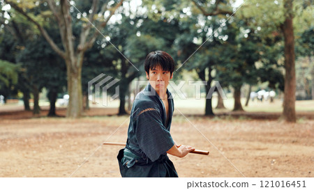 Bokken, Japanese man and outdoor for martial arts in training, exercise or sports as athlete. Culture, weapon and male person for heritage, combat and practice for self defense technique with bojutsu Bokken, Japanese man and outdoor for martial arts in training, exercise or sports as athlete. Culture, weapon and male person for heritage, combat and practice for self defense technique with bojutsu 121016451