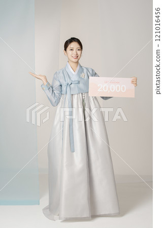 Portrait of a beautiful woman standing holding a shopping coupon while wearing an elegant and elegant hanbok Portrait of a beautiful woman standing holding a shopping coupon while wearing an elegant and elegant hanbok 121016456