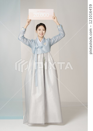 Portrait of a beautiful woman standing holding a shopping coupon while wearing an elegant and elegant hanbok 121016459