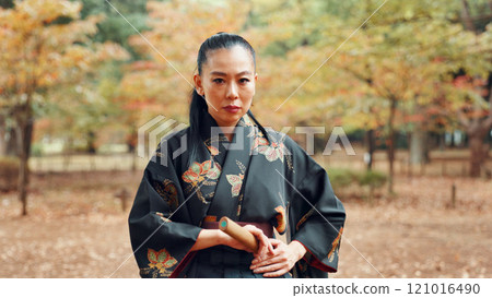 Portrait, serious and woman with kimono, martial arts and weapon for training, fighter and aikido. Woods, fitness and person with skills for bamboo sword, technique and discipline for kendo in Japan 121016490