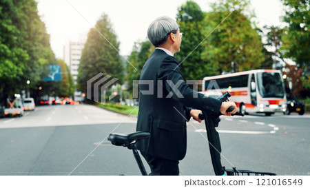 Business, man and walking with e bike in city for sustainable transport, eco friendly and carbon neutral travel. Mature person, electric bicycle and morning commute, urban journey and Japan adventure Business, man and walking with e bike in city for sustainable transport, eco friendly and carbon neutral travel. Mature person, electric bicycle and morning commute, urban journey and Japan adventure 121016549