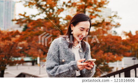 Travel, laughing and woman with phone at park with meme, gif and comedy blog on notification app in Japan. Funny, mobile and Asian person outdoor for chat, reading post and social media on vacation Travel, laughing and woman with phone at park with meme, gif and comedy blog on notification app in Japan. Funny, mobile and Asian person outdoor for chat, reading post and social media on vacation 121016606
