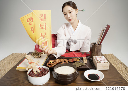 A shaman wearing a hanbok and giving an amulet A shaman wearing a hanbok and giving an amulet 121016678