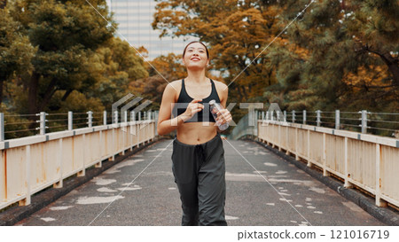 Woman, running and thinking on health in town, fitness and outdoor nature for dream of weight goals. Female person, urban park and reflection on exercise results, bottle and cardio workout in Japan Woman, running and thinking on health in town, fitness and outdoor nature for dream of weight goals. Female person, urban park and reflection on exercise results, bottle and cardio workout in Japan 121016719