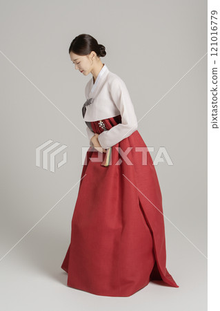 A woman in her 20s wearing a hanbok and greeting you in a polite manner A woman in her 20s wearing a hanbok and greeting you in a polite manner 121016779