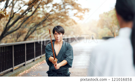 Instructor, bamboo sword and Asian man in city for martial arts, Kendo practice and exercise. Culture, heritage and person with shinai and bokuto for skill, fight and traditional training in Japan Instructor, bamboo sword and Asian man in city for martial arts, Kendo practice and exercise. Culture, heritage and person with shinai and bokuto for skill, fight and traditional training in Japan 121016858