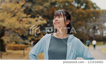 Thinking, nature and woman with running for exercise outdoor with health, wellness and activity. Idea, park and female person with cardio workout for marathon, challenge or race training in Japan. Thinking, nature and woman with running for exercise outdoor with health, wellness and activity. Idea, park and female person with cardio workout for marathon, challenge or race training in Japan. 121016882