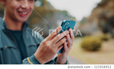 Hands, fitness and smile with phone in park searching for online exercise program for health. Sports, cellphone and athlete person browsing website for workout, routine and outdoor in Japan nature Hands, fitness and smile with phone in park searching for online exercise program for health. Sports, cellphone and athlete person browsing website for workout, routine and outdoor in Japan nature 121016912