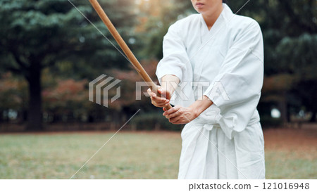 Bokken, Japanese person and outdoor for martial arts in training, exercise or sports as athlete. Woman, weapon and heritage for challenge, combat and practice for self defense technique with bojutsu Bokken, Japanese person and outdoor for martial arts in training, exercise or sports as athlete. Woman, weapon and heritage for challenge, combat and practice for self defense technique with bojutsu 121016948