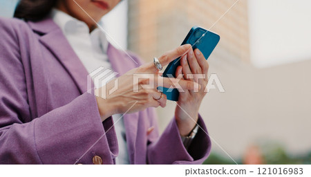 City, business and hands of woman with phone for communication, social media and networking. Professional commute, travel and person on smartphone for online email, mobile app and website in Japan 121016983