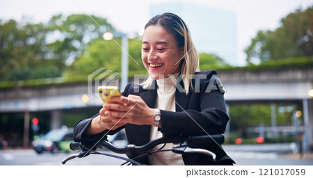 Phone, bicycle and business woman laugh at meme, gif and cycling on commute to work in Japan. Mobile, bike and happy worker in city to travel on sustainable transport, text or reading on social media 121017059