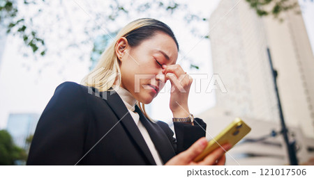 Frustrated, asian woman or phone with headache in city for company bankruptcy, debt or mistake. Japan, female person or employee with migraine or mobile smartphone in strain, financial crisis or fail 121017506