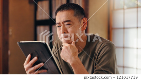 Tablet, thinking or Asian man in home reading for remote work, research or website in Japan. Face, mature author or creative freelancer with touchscreen for online campaign, article ideas and project 121017719