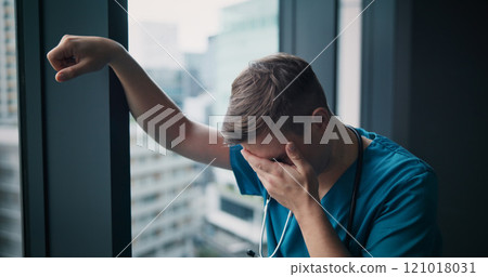 Stress, man and doctor in hospital with healthcare mistake, crisis or fail in treatment plan. Upset, burnout and male medical worker crying with grief for patient loss in surgery at clinic in Japan. 121018031